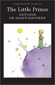 The Little Prince by Antoine de Saint-Exupéry book cover. Boy stands on asteroid looking at stars.
