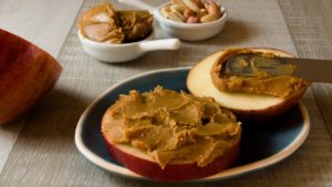 Peanut Butter spread on a sliced apple