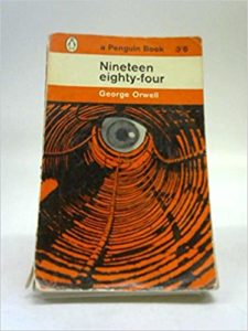 Nineteen Eighty-Four by George Orwell book cover. Image is of an eye peering down a hole. 