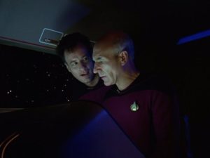 Patrick Stewart as Captain Picard and John de Lancie as Q