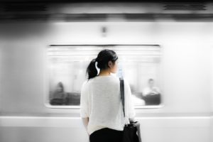 Woman standing and waiting for a subway car to stop