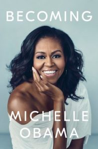 Becoming by Michelle Obama book cover. Image on the front of it is of Mrs. Obama smiling and looking straight ahead at the viewer. 