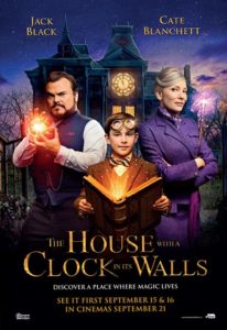 Poster for the film The House with a Clock in Its Walls. The three main characters from that film are smiling and looking straight ahead in it. One is holding a book and the other holds a light. 