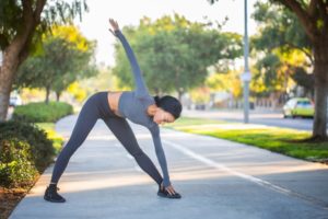 Woman stretching over to touch her toes before a run. 