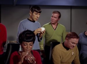 Leonard Nimoy as Mr. Spock. He and Uhura are holding tribbles while Captain Kirk (William Shatner) and Ensign Freeman (Paul Baxley) look on. 