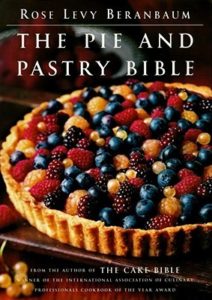 The Pie and Pastry Bible by Rose Levy Beranbaum book cover. Image on cover is of a bumble berry pie that does not have a top crust. 