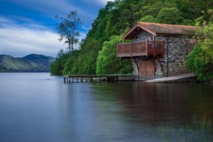 Stone house overlooking a lake. 