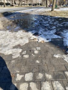 A running trail covered in slushy snow and half-melted ice. 