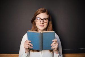 Woman holding a book and smiling