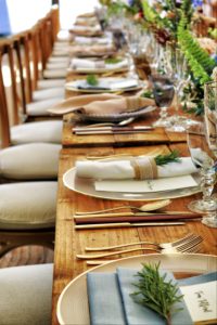 A wooden table set for a dinner party. 