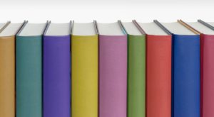 Books in assorted colours with blank spines. 
