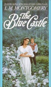 The Blue Castle by L.M. Montgomery book cover. Image on cover is of two lovers walking in a rose garden. 
