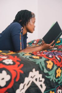 Black Woman reading a book 