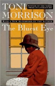 Book cover for The Bluest Eye by Toni Morrison. Image on cover is of african-american girl sitting by a window in the 1940s era. 