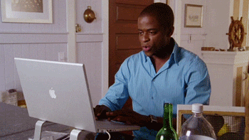 Burton Guster from Psych typing on a laptop
