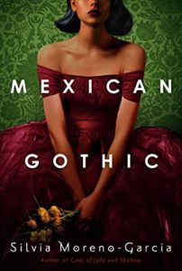 Mexican Gothic by Silvia Moreno-Garcia book cover. Image on cover is of a young girl wearing a red dress, clasping flowers, and sitting down. 