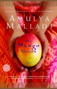 The Mango Season by Amulya Malladi book cover. Image on cover is of a woman holding a mango. 