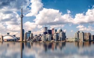 Toronto, Canada skyline. The famous CN Tower is one of the buildings in this shot. The foreground is of part of Lake Ontario 