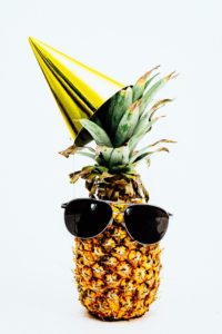 pineapple wearing sunglasses and a party hat