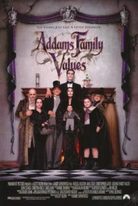 Film poster for Addams Family Values. Image on poster is of entire Addams family posing eerily and humorously in front of a large fireplace