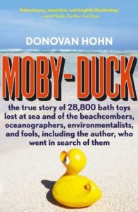 Moby-Duck by Donovan Hohn book cover. Image on cover is of a rubber duckie sitting on a patch of sand at the beach. 