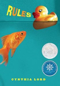 Rules by Cynthia Lord book cover. Image on cover is of a goldfish swimming in some water and looking at a rubber duckie floating on top of the water.