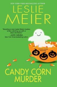 Candy Corn Murder (A Lucy Stone Mystery, #22) by Leslie Meier book cover. Image on cover is of a small ghost playfully peeking out of a bowl filled with candy corn