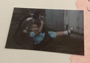 A preschooler swinging in a tire swing