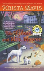 The Ghost and Mrs. Mewer (Paws and Claws Mystery, #2) by Krista Davis book cover. Image on cover is of a cat and dog looking at smashed halloween pumpkin on a residential driveway. 