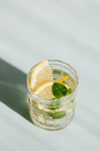 glass of alcohol on white surface