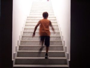 Child running up a flight of steps