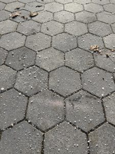 Salt scattered on a sidewalk. 