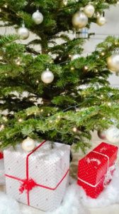 wrapped gifts sitting beneath a christmas tree