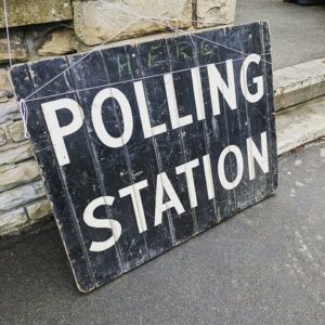Black and white sign that says "polling station"