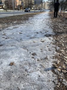 A dirt running trail covered in ice. 