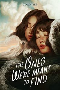The Ones We're Meant to Find  by Joan He book cover. Image on cover shows two young woman closing their eyes and touching their heads together. 