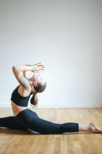 Woman doing yoga on a wooden floor