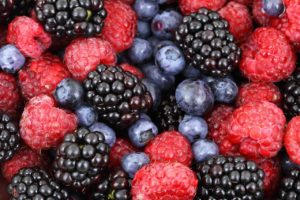 close-up photo of fresh raspberries, blackberries, and blueberries