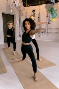 three women doing yoga