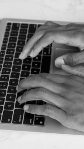 Closeup photo of person typing on laptop keyboard