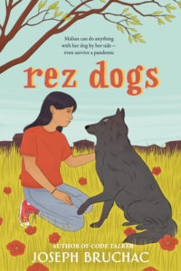 Rez Dogs by Joseph Bruchac book cover. Image on cover is of a native child petting a dog in a field.
