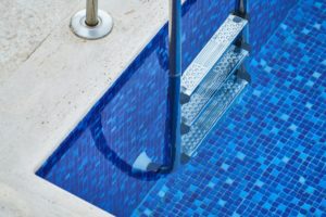 Swimming pool with stainless steel ladder