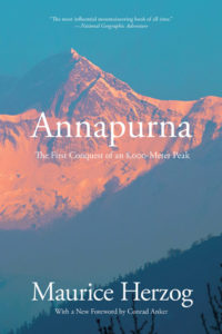 Annapurna- The First Conquest of an 8,000-Meter Peak by Maurice Herzog book cover. Image on cover shows sun setting on Annapurna mountain peak. 