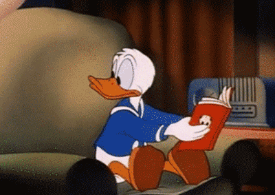Donald Duck reading a book. As he looks away, black claws emerge from the book to grab him. 