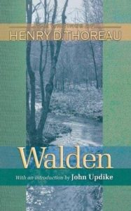 Walden by Henry David Thoreau book cover. Image on cover is a black-and-white photo of a stream flowing thorugh a forest. 