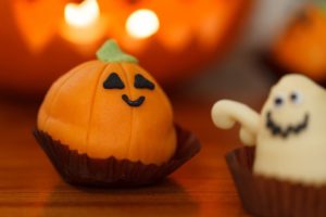 Candies made to look like a pumpkin and a ghost. 