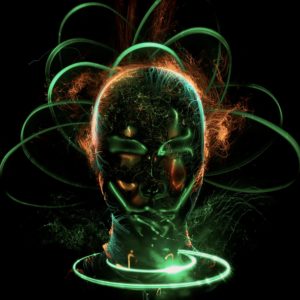 An artistic and metallic rendition of a human head. There are green beams of light shooting out from and circling it.