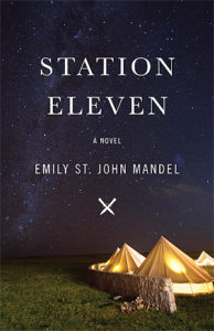 Station Eleven by Emily St. John Mandel book cover. Image on cover shows tents with lights shining in them. The tents have been placed on a grassy field. It’s midnight and dark out. 