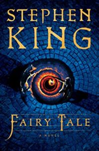 Fairy Tale by Stephen King Book cover. Image on cover shows a spiral staircase in a stone pathway. The staircase is illuminated with red and yellow light and looks like an eye. 