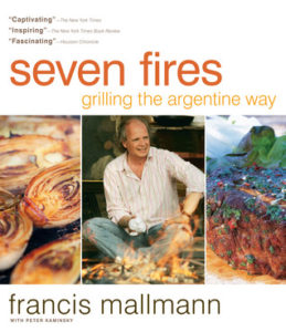 Seven Fires: Grilling the Argentine Way by Francis Mallmann book cover. Image on cover hows photograph of a man, the barbecued food he cooks, and the land he lives on. 